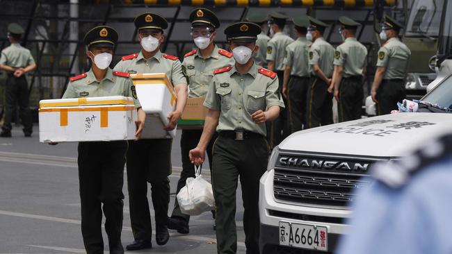 Paramilitary police officers prepare food supplies outside the Xinfadi market in Beijing. Picture: AFP