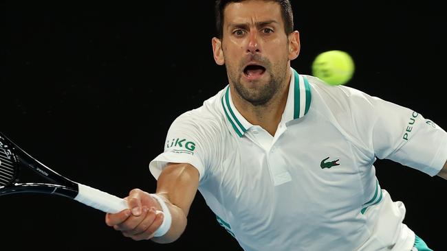 Serbia's Novak Djokovic hits a return against Canada's Milos Raonic