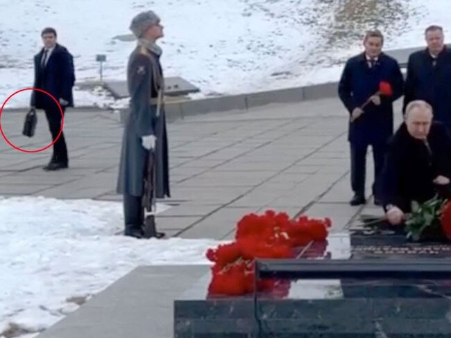 Two of Putin's aides seen with briefcases - one of which is thought to contain the Kremlin's nuke button