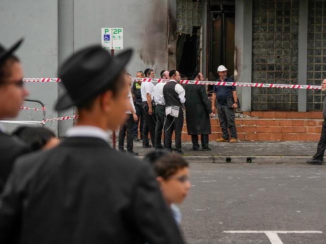 MELBOURNE, AUSTRALIA - DECEMBER 06: Members of the local Jewish community look at the damage of the arson attack at the  Adass Israel Synagogue on December 06, 2024 in Melbourne, Australia. An arson attack on the Adass Israel Synagogue in Melbourne forced congregants to flee as flames engulfed the building early on Friday morning. Prime Minister Anthony Albanese condemned the incident as an antisemitic act, emphasizing that such violence at a place of worship is unacceptable in Australia. (Photo by Asanka Ratnayake/Getty Images)