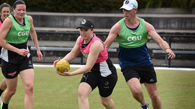 Jess Duffin trains during Collingwood's AFLW training camp as a familiar face gives chase, premiership captain Nick Maxwell. Picture: Collingwood FC