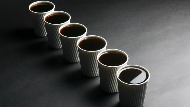 Six or more coffees a day can be detrimental to health. Generic instant coffee images. Line up of six cups of coffee in takeaway cups