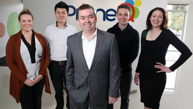 PrimeQ chief executive Andrew McAdams (centre) with staff at the company’s Kent Town offices. Photo - Calum Robertson