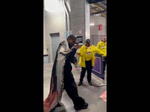 Usher arrives at the Super Bowl all rugged up