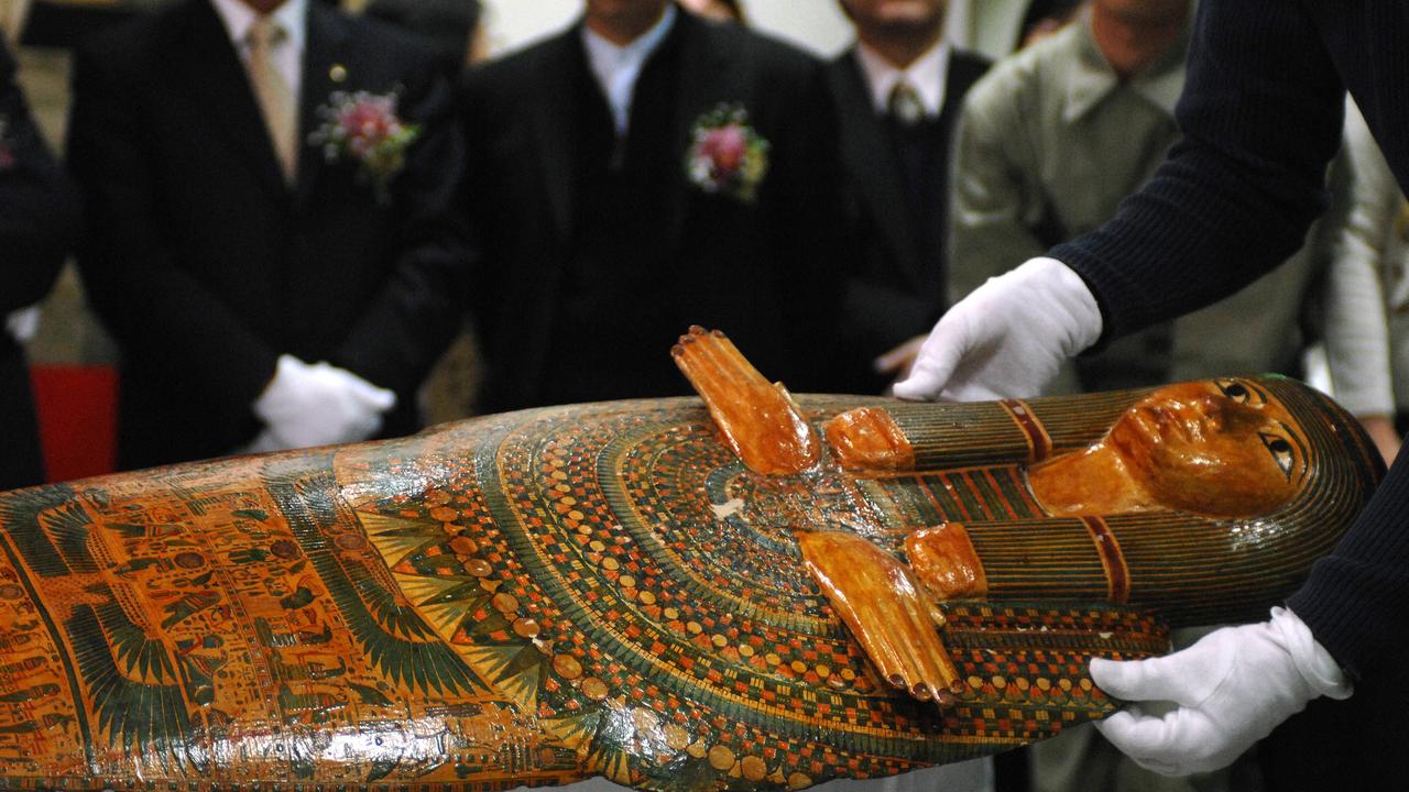 A worker displays the 'Unlucky Mummy', from 945 BC, displayed by the British Museum during a press conference at Taiwan's National Palace Museum in Taipei 24 January 2007. According to the British museum, the 'Unlucky Mummy' is not a mummy at all, but rather a gessoed and painted wooden 'mummy-board' or inner coffin lid, found at Thebes. It is referred to as the 'Unlucky Mummy' as it has acquired a reputation for bringing misfortune. Some 271 pieces of antiques from the British Museum will be exhibited at Taiwan's National Palace Museum betwen 04 Febuary to 27 May 2007. AFP PHOTO/Sam YEH
