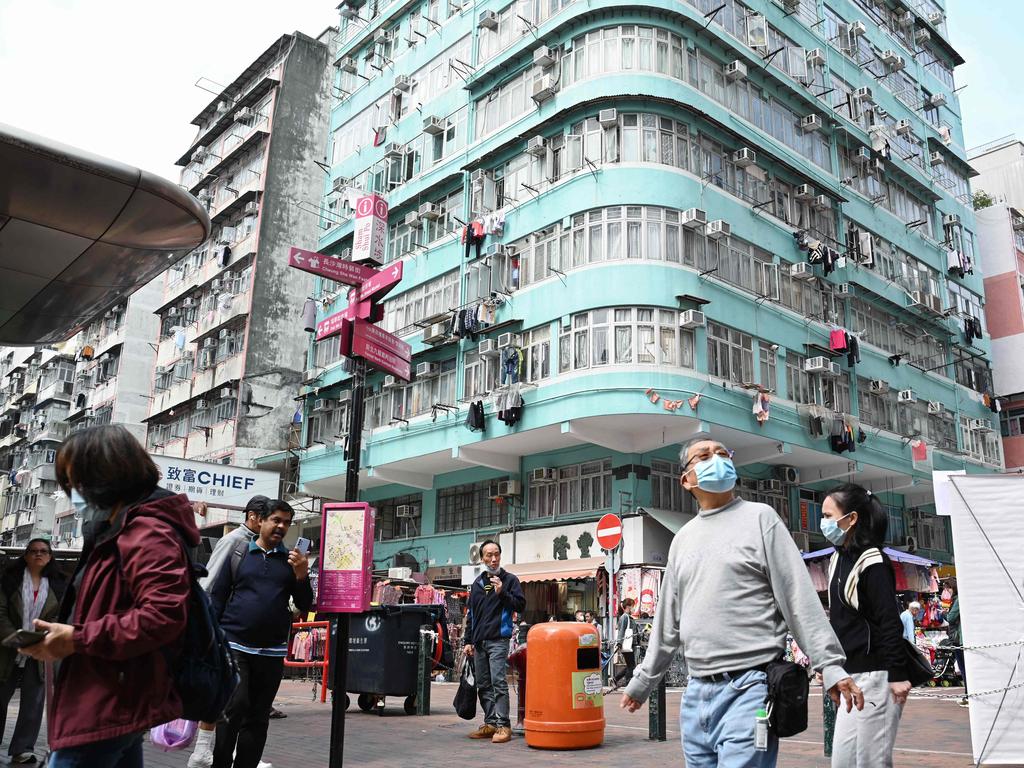People walk through a neighbourhood in the Kowloon district of Hong Kong. Picture: Peter Parks/AFP