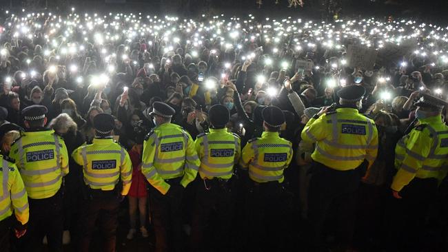 Police officers form a cordon at a vigil for murder victim Sarah Everard. This is not Myanmar during a military coup. This is south London during COVID-19. Picture: AFP