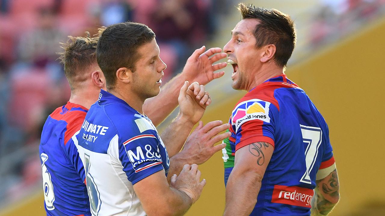 Mitchell Pearce of the Knights reacts after a try as Jack Cogger laments the loss.