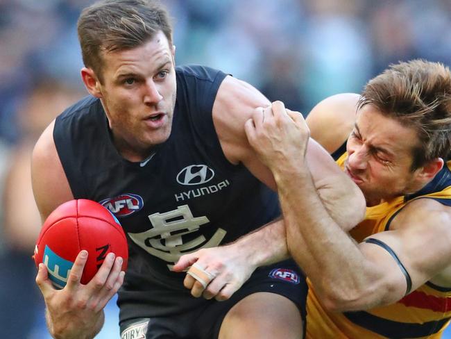 MELBOURNE, VICTORIA - JULY 01:  Sam Docherty of the Blues is tackled by Richard Douglas of the Crows during the round 15 AFL match between the Carlton Blues and the Adelaide Crows at Melbourne Cricket Ground on July 1, 2017 in Melbourne, Australia.  (Photo by Scott Barbour/AFL Media/Getty Images)