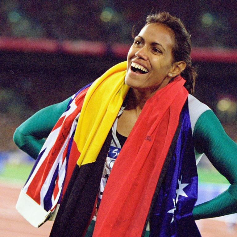 Cathy Freeman draped in the Australian and Aboriginal flags after her win in the Sydney Olympics.