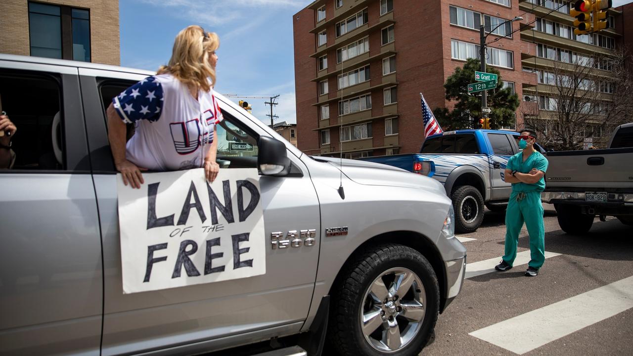 Hundreds took to Denver streets to protest stay-at-home rules, to be met buy healthcare workers calmly reminding why they were in place. Picture: Alyson McClaran