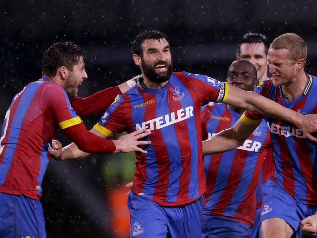 Crystal Palace's captain Mile Jedinak, second left, celebrates scoring his side's third goal with during the English Premier League soccer match between Crystal Palace and Liverpool at Selhurst Park stadium in London, Sunday, Nov. 23, 2014. (AP Photo/Matt Dunham)