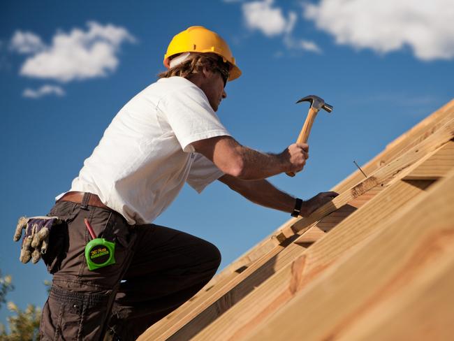 worker on a roof with hammer, generic tradesman