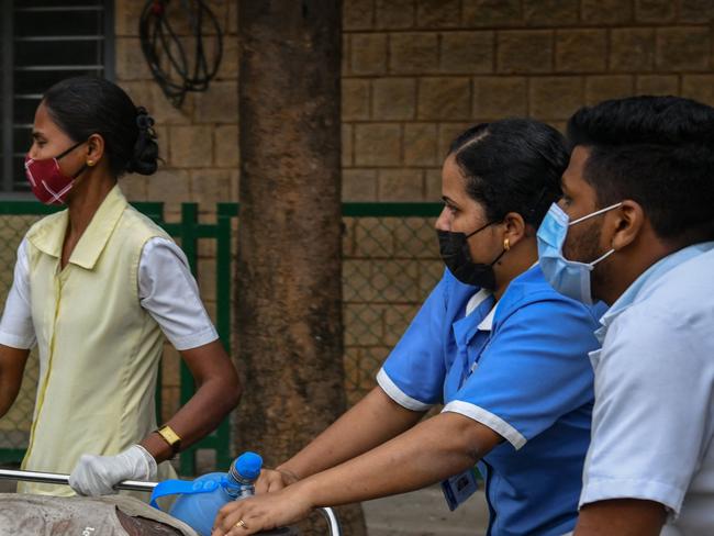 EDITORS NOTE: Graphic content / Emergency medical and rescue personnel move a victim to safety after a concrete slab of a portico collapsed trapping four people underneath at the St Marthaâs Hospital in Bangalore on May 31, 2022. (Photo by Manjunath Kiran / AFP)