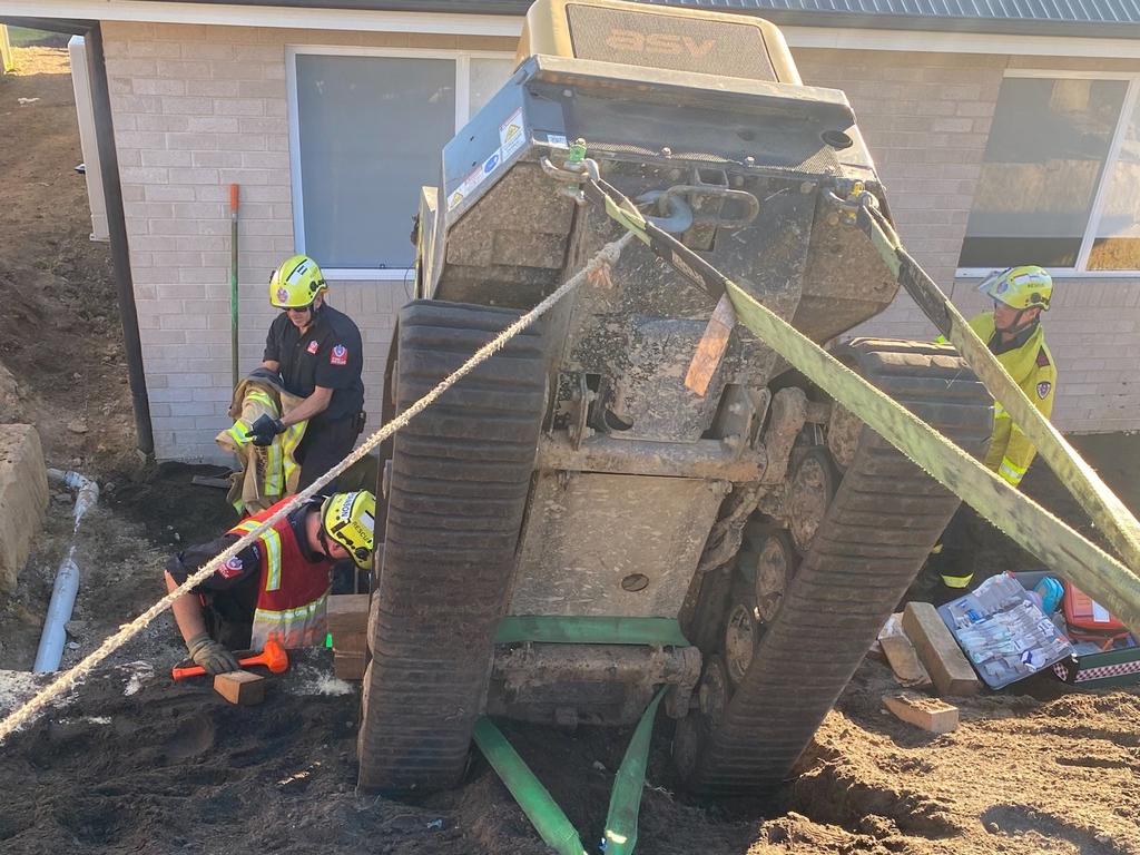 A man was pinned by his leg beneath the tracks of the heavy earth moving machine. Image: FRNSW