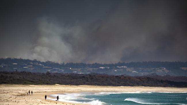 Smoke is seen in the distance near Tuncurry, NSW.