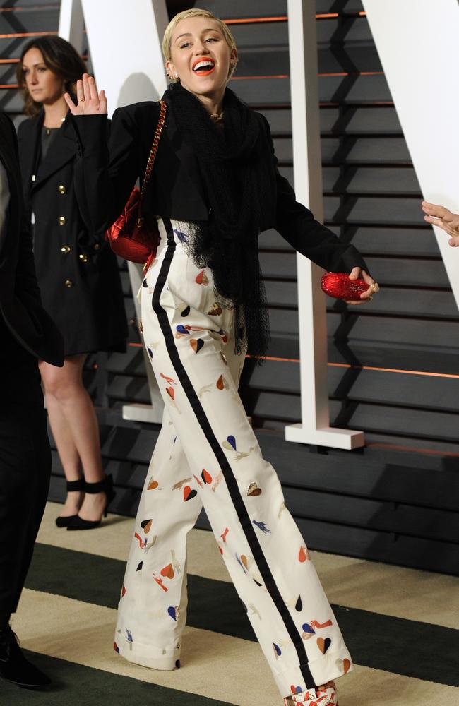 A leggy Miley Cyrus arrives at Vanity Fair Oscar Party.