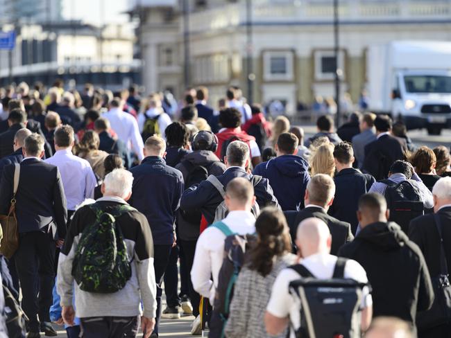 Large crowd of people commuting to work in London, England