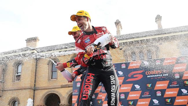 Jamie Whincup celebrates with champagne outside Customs House. Picture: Daniel Kalisz/Getty