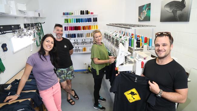 <span id="U701971942177XI" style="font-weight:bold;font-style:normal;">ECO FRIENDLY:</span> Shirtbox founder Christian Miller (right) with operations manager Maren Eibner (left) and production staff Steven Burns and Dea Beros. The company produces its own power, uses chemical-free printing processes and its T-shirts are made from organic cotton or recycled polyester. Picture: STEWART McLEAN