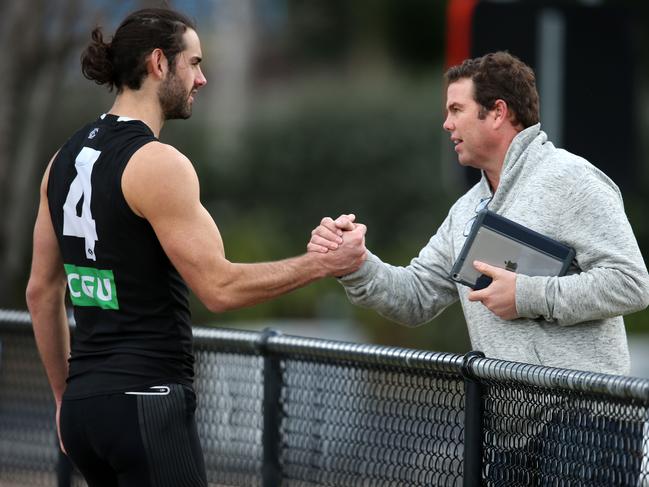 Collingwood training at Olympic Park.  Player manager Paul Connors shakes hands with Brodie Grundy at training today   . Pic: Michael Klein