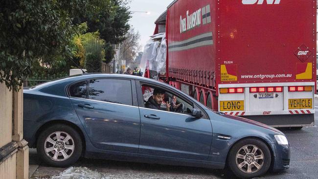 A man leaves his driveway after the accident. Picture Mark Brake