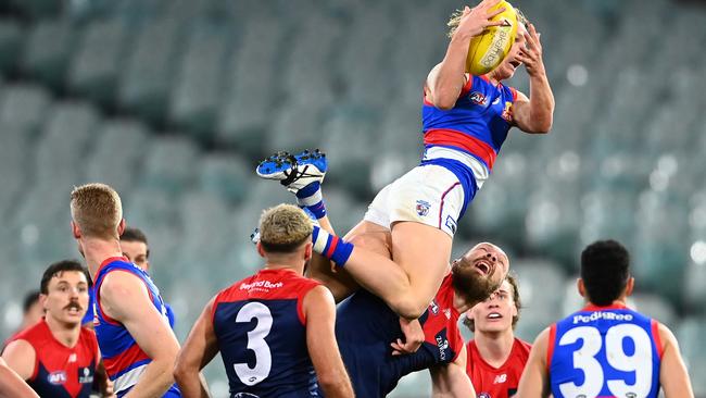 Cody Weightman climbs on top of Max Gawn to take an incredible mark at the MCG. Pictures: Getty Images