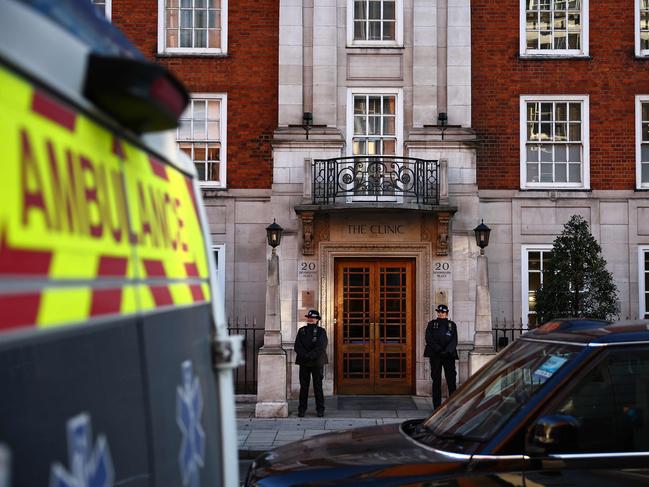 An ambulance waits opposite police officers standing guard outside the London Clinic in London where Catherine, Princess of Wales, underwent surgery. Picture: AFP