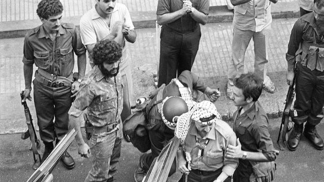 Palestine Liberation Organization Chairman Yasser Arafat, wearing a kaffiyeh, is seen in this 1982 picture in Beirut, surrounded by heavy security as he leaves the Israeli-occupied city for Tunisia. Picture: AFP/Getty Images