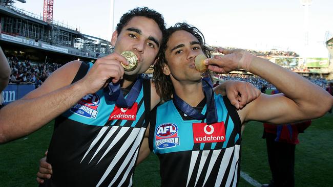 Port Adelaide champions Shaun and Peter Burgoyne wearing the Power’s teal-infused strip in the triumphant 2004 AFL grand final. Picture: Ryan Pierse/Getty Images