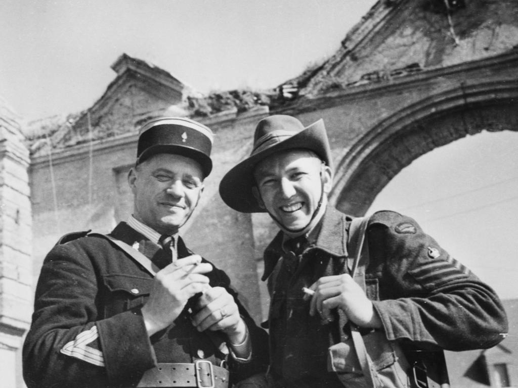 Back in France … Flight Sergeant Fred Wood, of Adelaide, with a French policeman in a liberated Normandy village. Picture: the Australian War Memorial