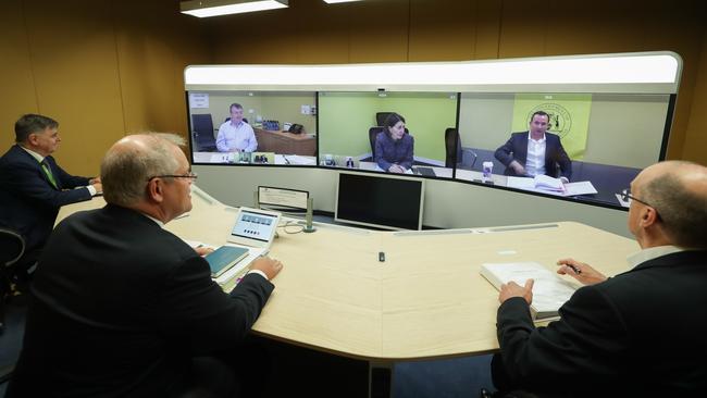 Australia’s chief medical officer Professor Brendan Murphy, Prime Minister Scott Morrison secretary of the Department of Prime Minister and Cabinet Phil Gaetjens, with (on screen L-SA Department of Premier and Cabinet chief executive Jim McDowell, NSW Premier Gladys Berejiklian and WA Premier Mark McGowan during a National Cabinet meeting on May 1. Picture: Alex Ellinghausen/pool