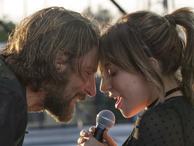 This image released by Warner Bros. shows Bradley Cooper, left, and Lady Gaga in a scene from the latest reboot of the film, "A Star is Born." (Neal Preston/Warner Bros. via AP)