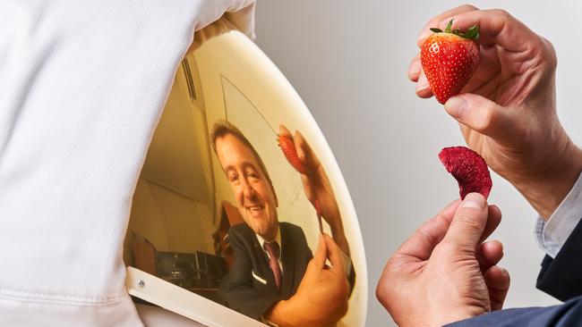 Professor Volker Hessel with two strawberries, one freeze-dried, at the University of Adelaide, where their team is working on improving the taste of Astronaut food. Picture: Matt Loxton