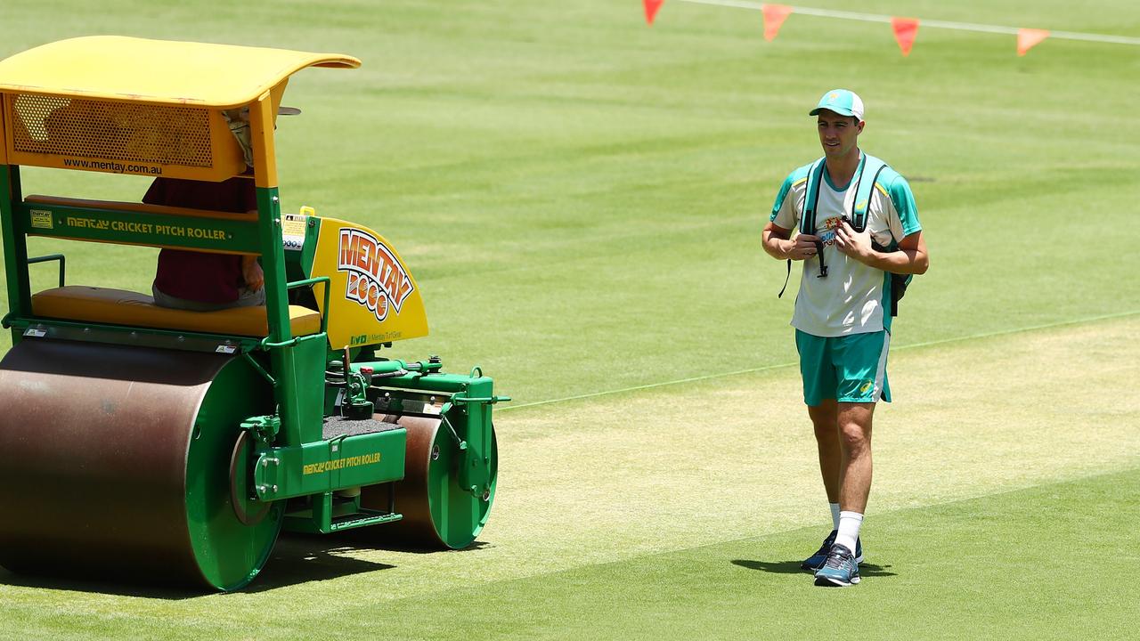 Pat Cummins inspects the Gabba pitch on first Test eve.