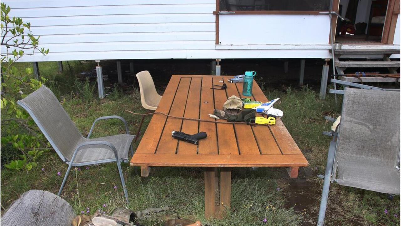 One of the slain officer’s taser and handgun sits on an outdoor table after being taken off their bodies by one of the Trains.