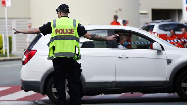 Police and SES checking people at the Queensland border. Picture: Nigel Hallett