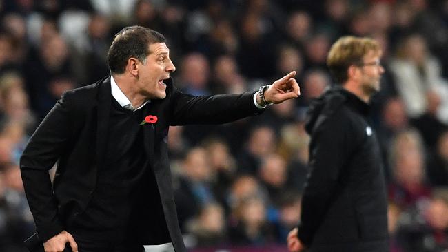 West Ham United's Croatian manager Slaven Bilic gestures next to Jurgen Klopp.