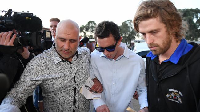 Salisbury West president (left) Frank Timpano leads Adam Jones (centre) into the tribunal alongside Tigers player Justin Davies (right). Picture: Brad Fleet.