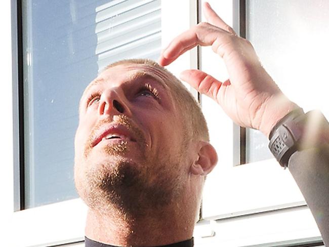 This handout picture made and released on July 19, 2015 by the World Surf League (WSL) shows Australian surfer Mick Fanning (L) looking up after he was attacked by a shark during the J-Bay Open final in Jeffreys Bay. Mick Fanning, 34, was competing in the final heat of a world tour event at Jeffreys Bay in the country's Eastern Cape province when a looming black fin appeared in the water behind him. He fought back against the shark, escaping from the terrifying scene without injury. AFP PHOTO / WSL / KELLY CESTARI ==RESTRICTED TO EDITORIAL USE - MANDATORY CREDIT "AFP PHOTO / WSL / KELLY CESTARI" - NO MARKETING - NO ADVERTISING CAMPAIGNS - DISTRIBUTED AS A SERVICE TO CLIENTS==