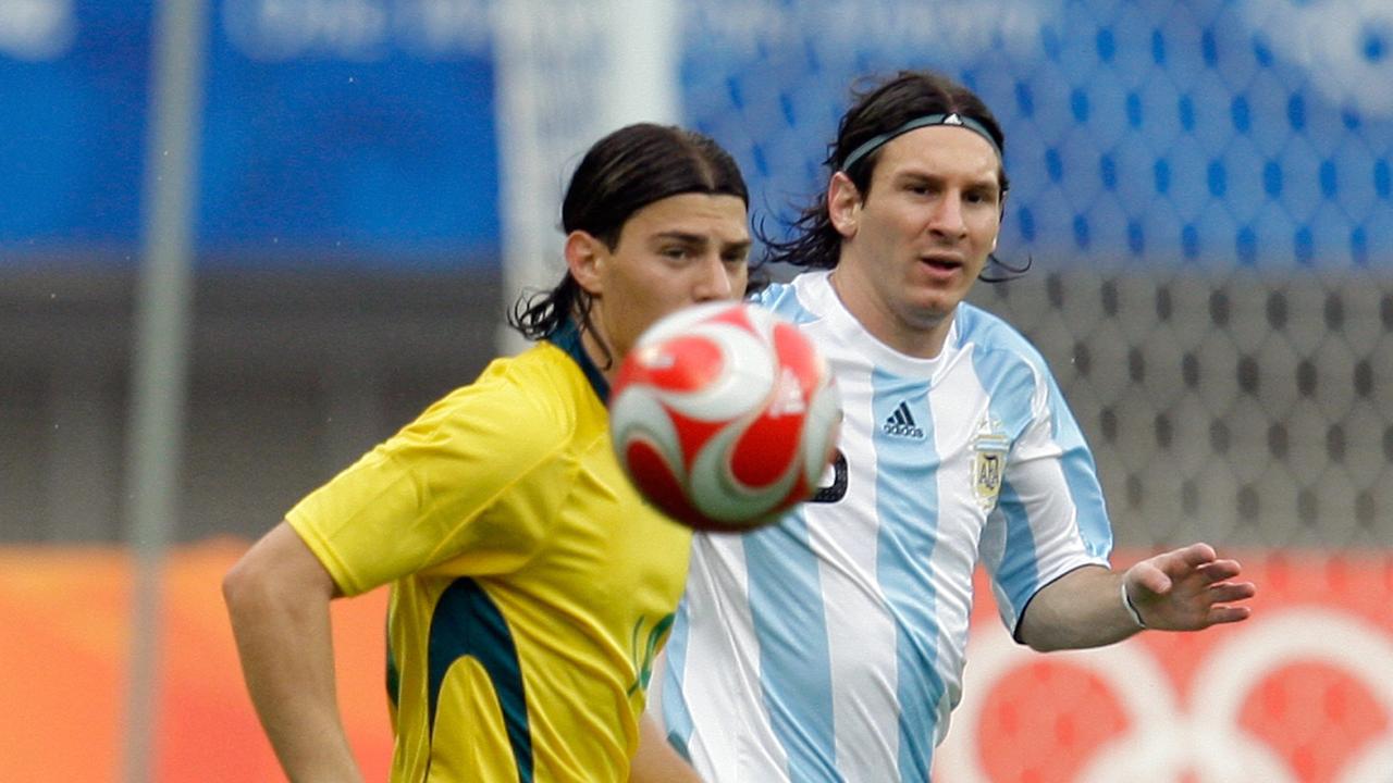 Argentina's player Lionel Messi, (r), crosses the ball past Australia's James Troisi in the 2008 Beijing Olympics.