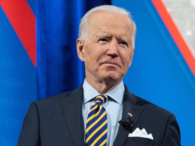 US President Joe Biden holds a face mask as he participates in a CNN town hall at the Pabst Theater in Milwaukee, Wisconsin, February 16, 2021. (Photo by SAUL LOEB / AFP)