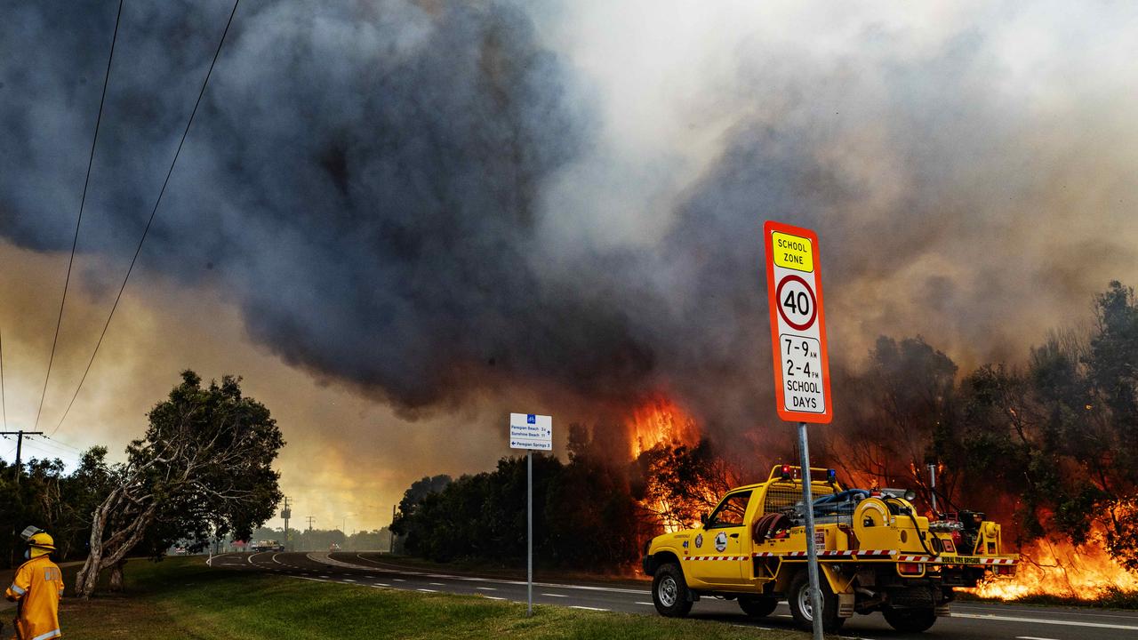 Firefighters on the scene at an out of control bushfire at Peregian Beach, where hundreds of residents were evacuated yet again. Photo Lachie Millard