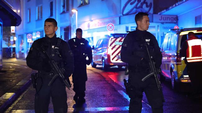 Police and ambulances stand near the scene where a several people died and several were injured in an attack. Picture: AFP