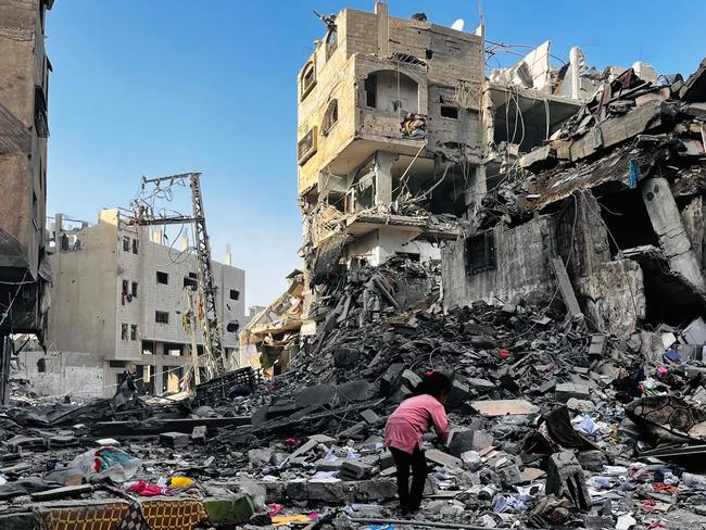 A Palestinian girl inspects the rubble of a building after an Israeli strike in Beit Lahia, in the northern Gaza Strip. Picture: AFP