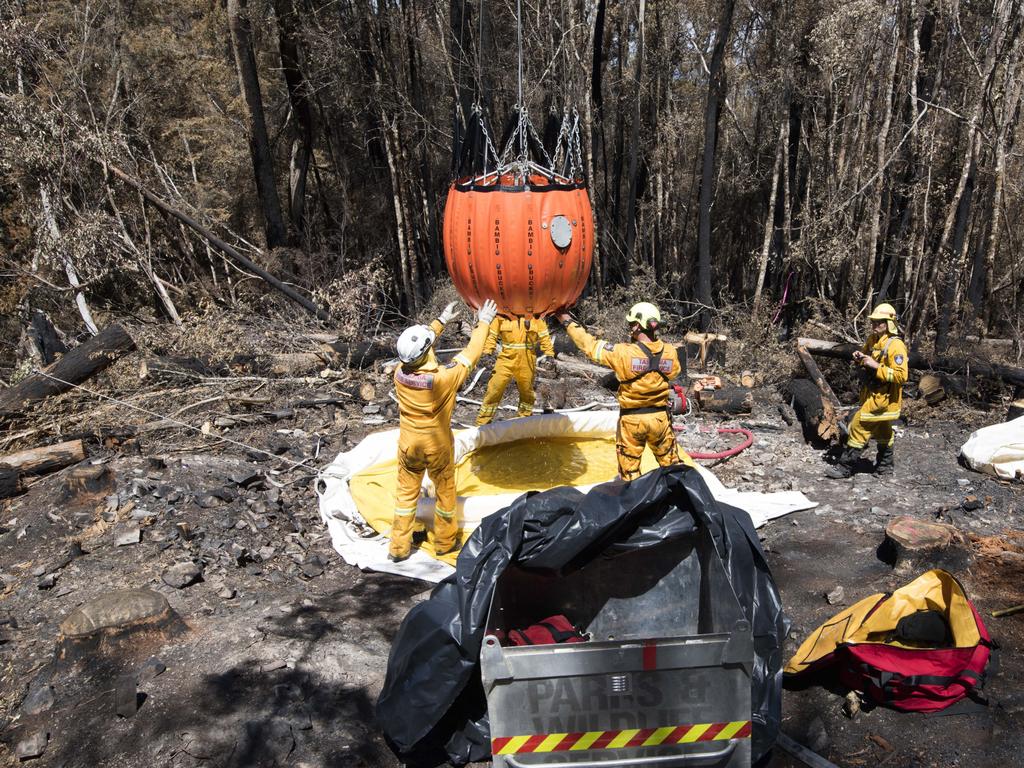 Gell River firefighters prepare a bucket for aerial firebombing. Picture: WARREN FREY/TASMANIA FIRE SERVICE