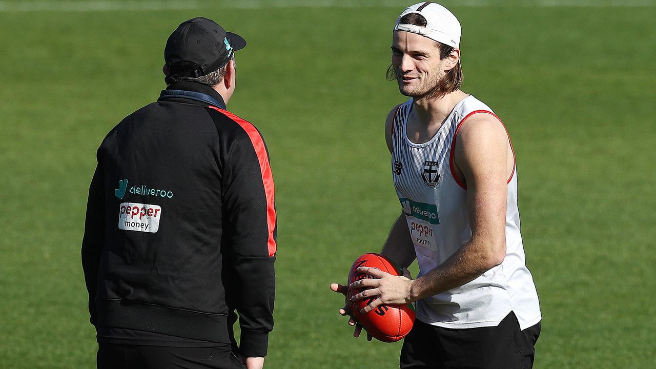 Clark chats with Brett Ratten during a training session. Picture: Michael Klein