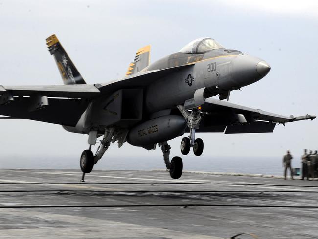 An F/A-18E Super Hornet lands on the deck of the USS George Washington during a joint US and South Korea military exercise in 2012. Picture: Song Kyung-Seok/Getty Images