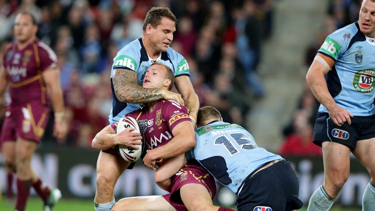 Daly Cherry-Evans tackled by former Manly teammate Anthony Watmough.