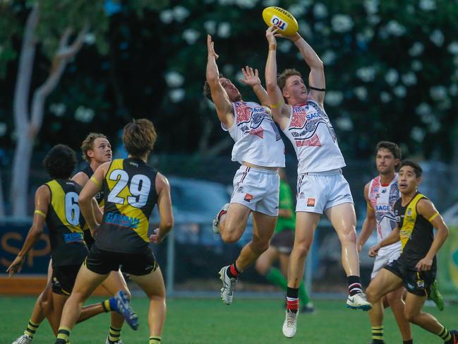 Southern Districts’ Jesse Clark takes a high mark during the first game under lights at Darwin Mazda Nightcliff Oval. Picture: Glenn Campbell